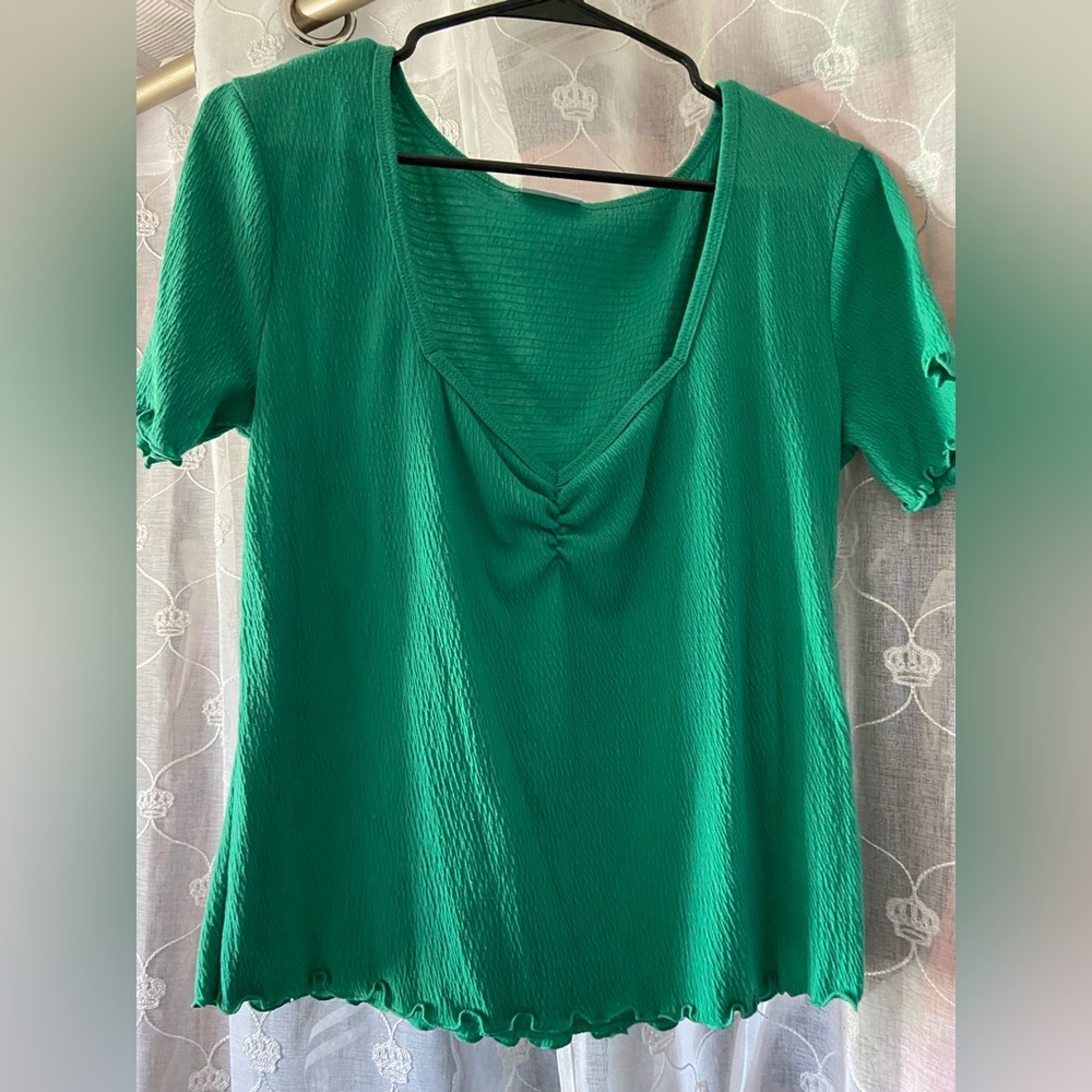 Green top with ruffle trimming